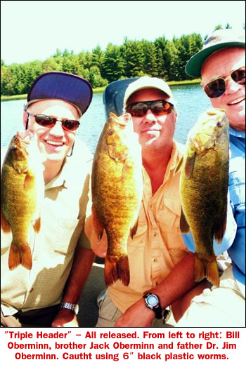 TRIPLE HEADER, SMALLMOUTH BASS, ALL RELEASED. FROM LEFT TO RIGHT, BIIL OBERMINN, BROTHER JACK OBERMINN, AND FATHER, DOCTOR JIM OBERMINN, ALL FROM MADISON WISC. ALL 3 USING 6 INCH BLACK PLASTIC WORMS. JUNE 15TH. 2010. LAKE TOMAHAWK WI.