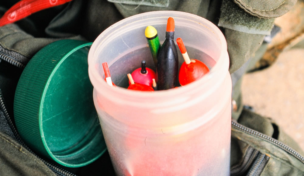 Sensitive pencil floats are integral to centerpin fishing. A used peanut butter jar makes a great container for carrying a selection of sizes and styles.